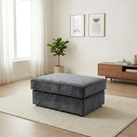 Velvet footstool with soft cushioning and classic style.