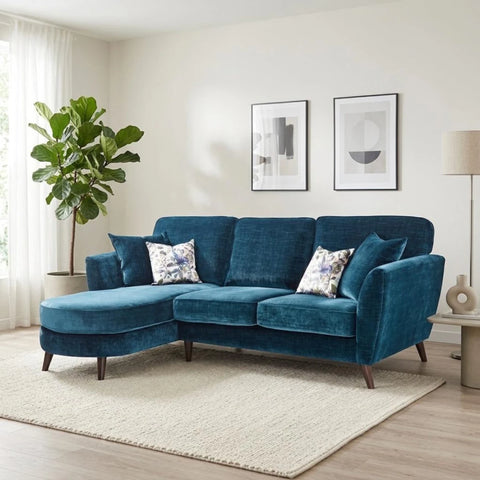 Elegant high back chaise sofa with botanical cushions and wooden legs.