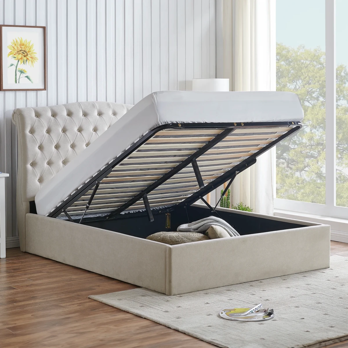 Rosina Ottoman Storage Luxe Bed. A beige upholstered storage bed with a tufted headboard, shown with the mattress lifted up to reveal the lift-up mechanism and storage compartment. Bed available in Dark Grey, Light Grey and Natural fabric.