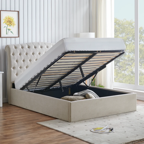 Rosina Ottoman Storage Luxe Bed. A beige upholstered storage bed with a tufted headboard, shown with the mattress lifted up to reveal the lift-up mechanism and storage compartment. Bed available in Dark Grey, Light Grey and Natural fabric.