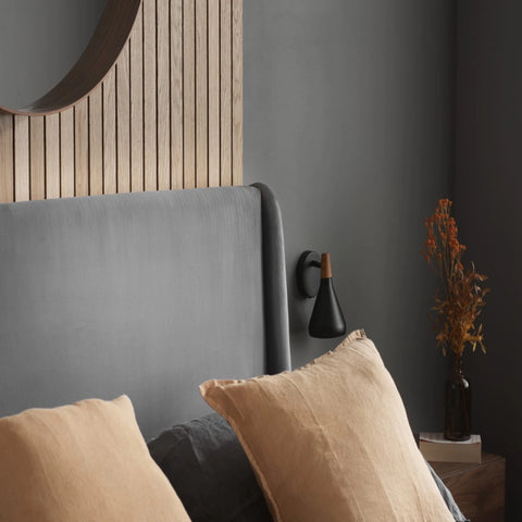 Modern bed with velvet upholstery and supportive structure.