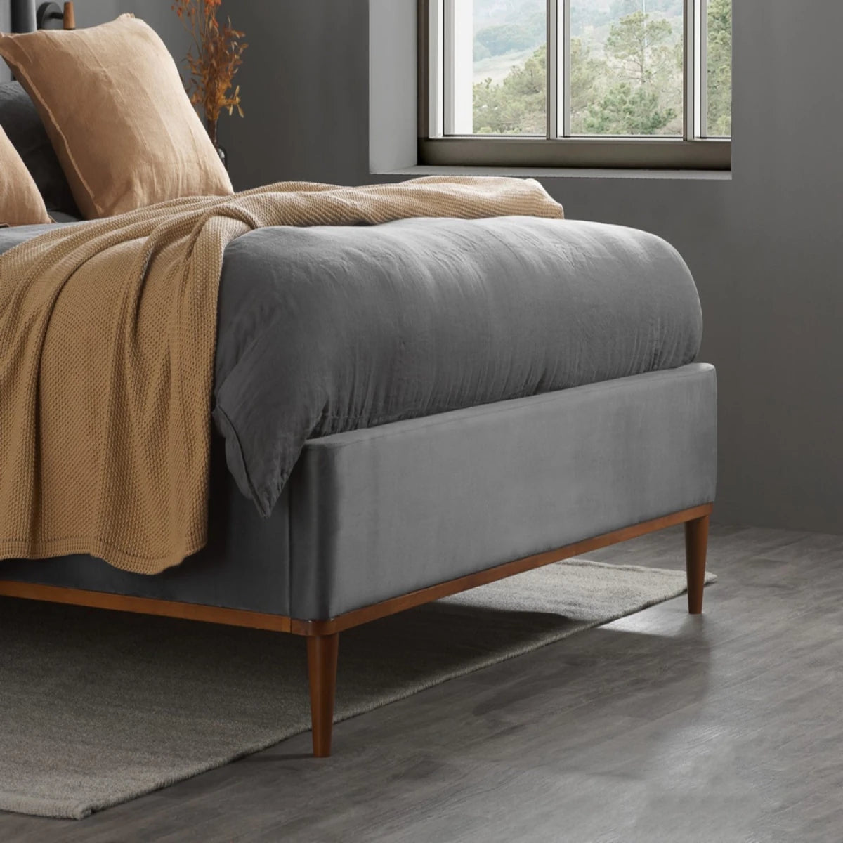 Elegant velvet bed frame with cushioned headboard and durable base.
