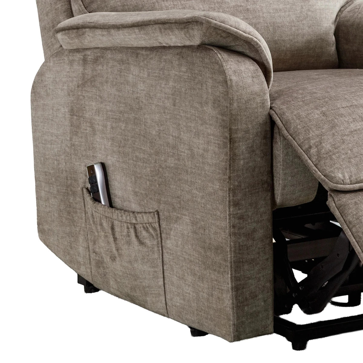 Close-up of a taupe Salford Rise and Recline chai , has padded High Back and Padded Arm Rests showing the side pocket holding a remote, with the footrest extended and black mechanical mechanism visible underneath.