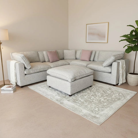 Modern sectional sofa with footstool for stylish interiors.