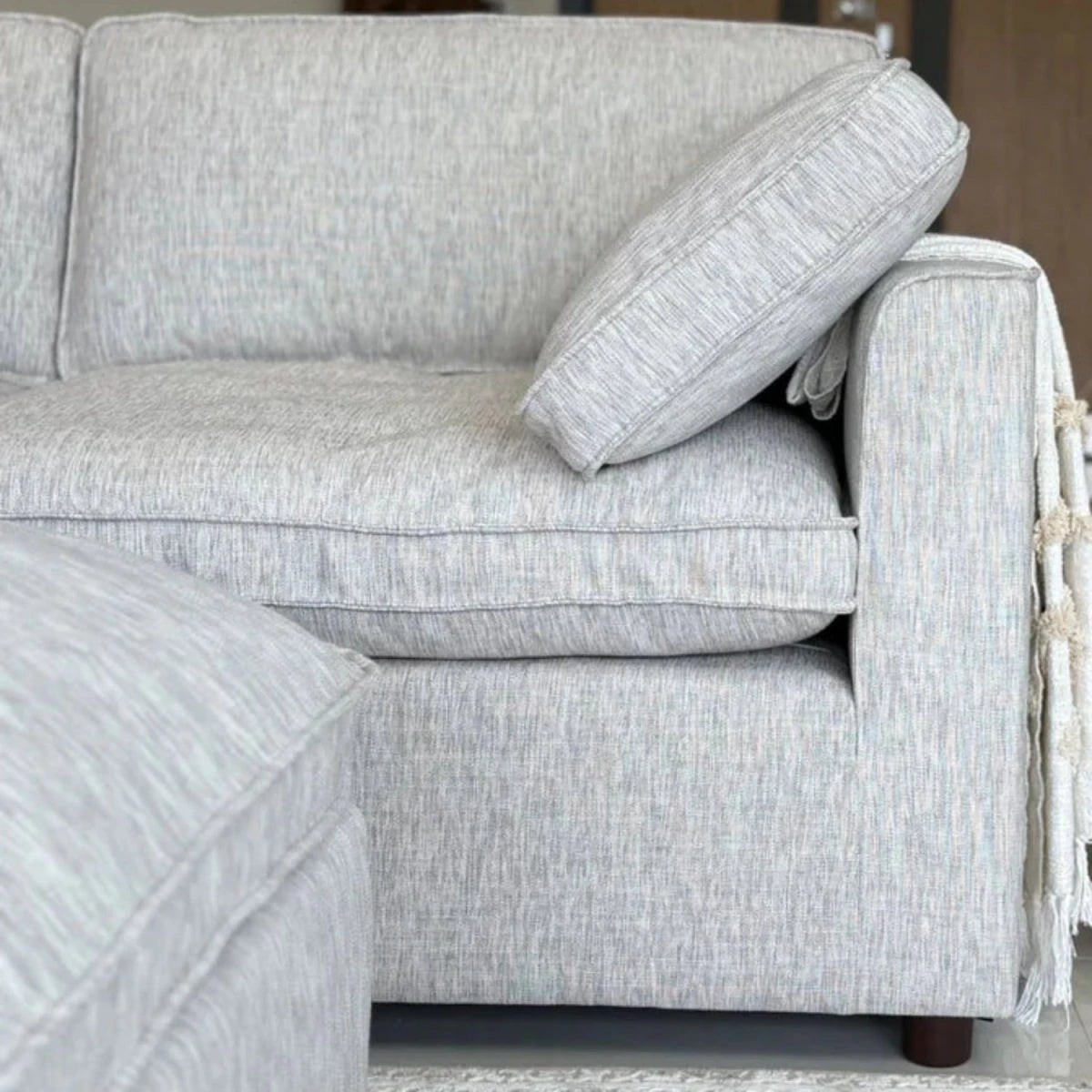 Soft-touch woven upholstery with modern neutral tone.