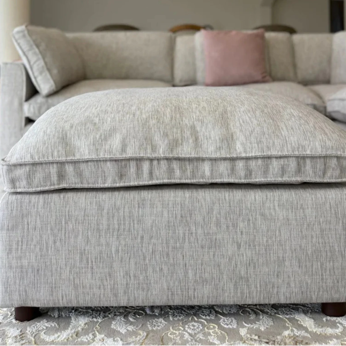 Matching footstool for use as footrest or extra seating.