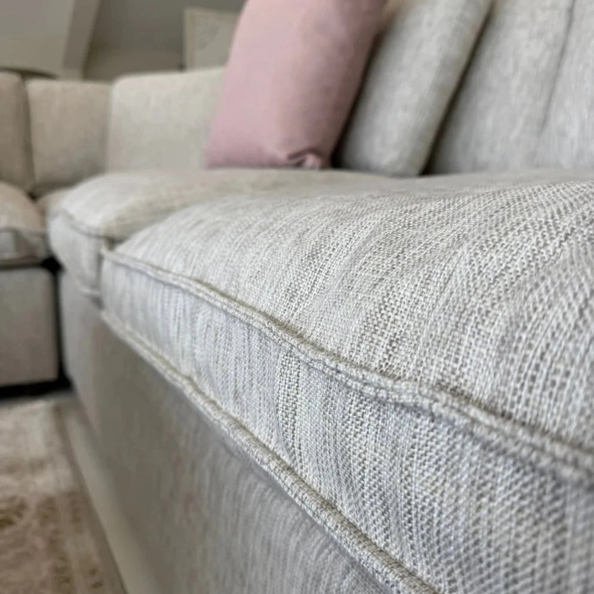 Grey upholstered sofa with durable and comfortable fabric finish.