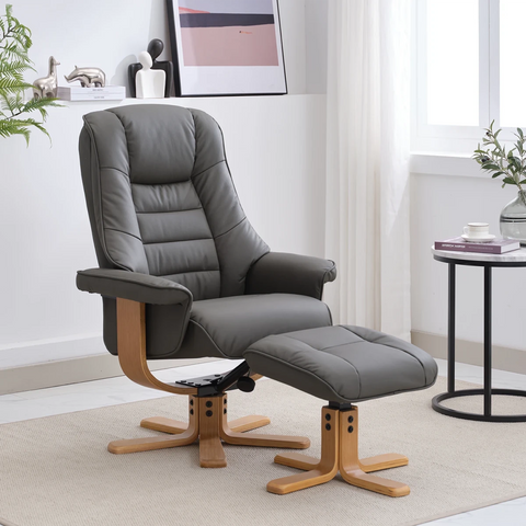 A modern gray leather recliner chair with a matching ottoman, both on wooden swivel bases, shown in a bright, contemporary living room setting.