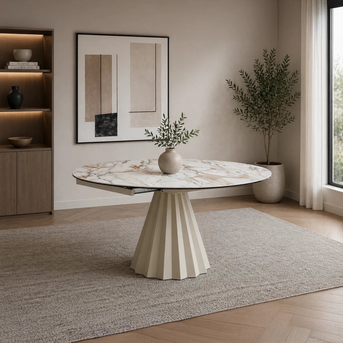 Round marble table in a modern living room with a neutral color scheme.