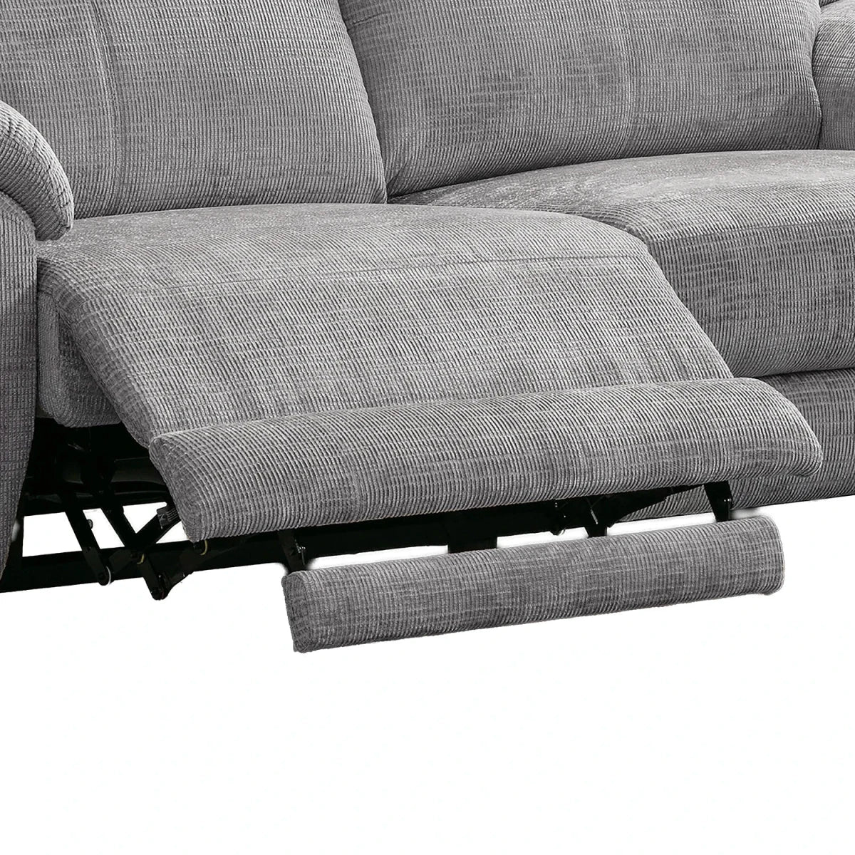 Close-up of a gray textured reclining sofa with the footrest extended, showing the fabric texture and black reclining mechanism against a white background.