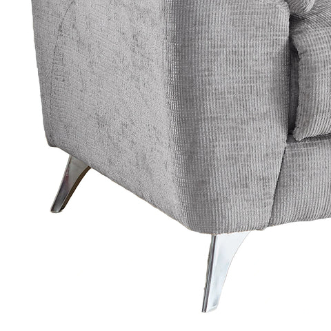 Close-up of a light gray textured fabric sofa showing the corner, seat cushion, and shiny metallic legs against a white background.