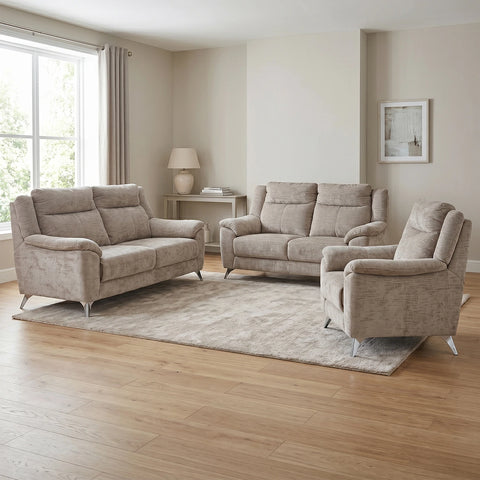 A three-piece upholstered living room furniture set in a light beige textured fabric, including a loveseat, a sofa, and an armchair, arranged on a large area rug in a modern living room with light wood floors.