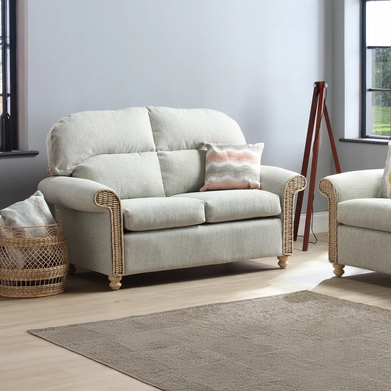 Desser Samford Rattan 2 Seater Sofa in Pebble Fabric, available in a 3 Seater, 2 Seater, Swivel Rocker, Swivel Chair, Armchair and Footsool.  Choose from various fabrics - Sofa in Lifestyle Image 