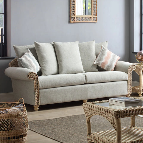 Desser Samford Rattan 3 Seater Sofa with Scatter Cushions in Pebble Fabric. Also available in 2 Seater, Swivel Chair, Swivel Rocker, Armchair and Footstool. Style with matching Coffee Table and Lamp Table. Choose from a variety of fabrics - 3 seater sofa in Lifestyle image