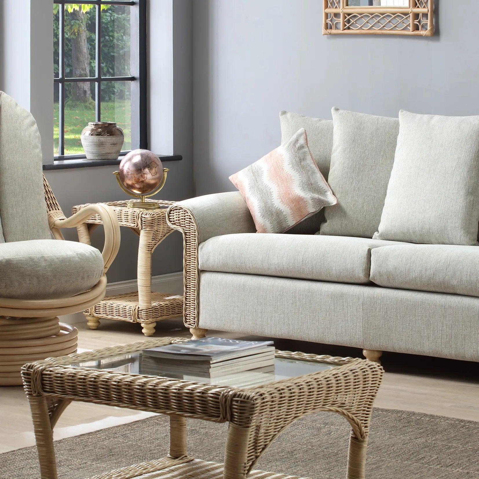 Desser Samford Rattan 3 Seater Sofa with Scatter Cushions in Pebble Fabric. Also available in 2 Seater, Swivel Chair, Swivel Rocker, Armchair and Footstool. Style with matching Coffee Table and Lamp Table. Choose from a variety of fabrics - Sofa with matching furniture 