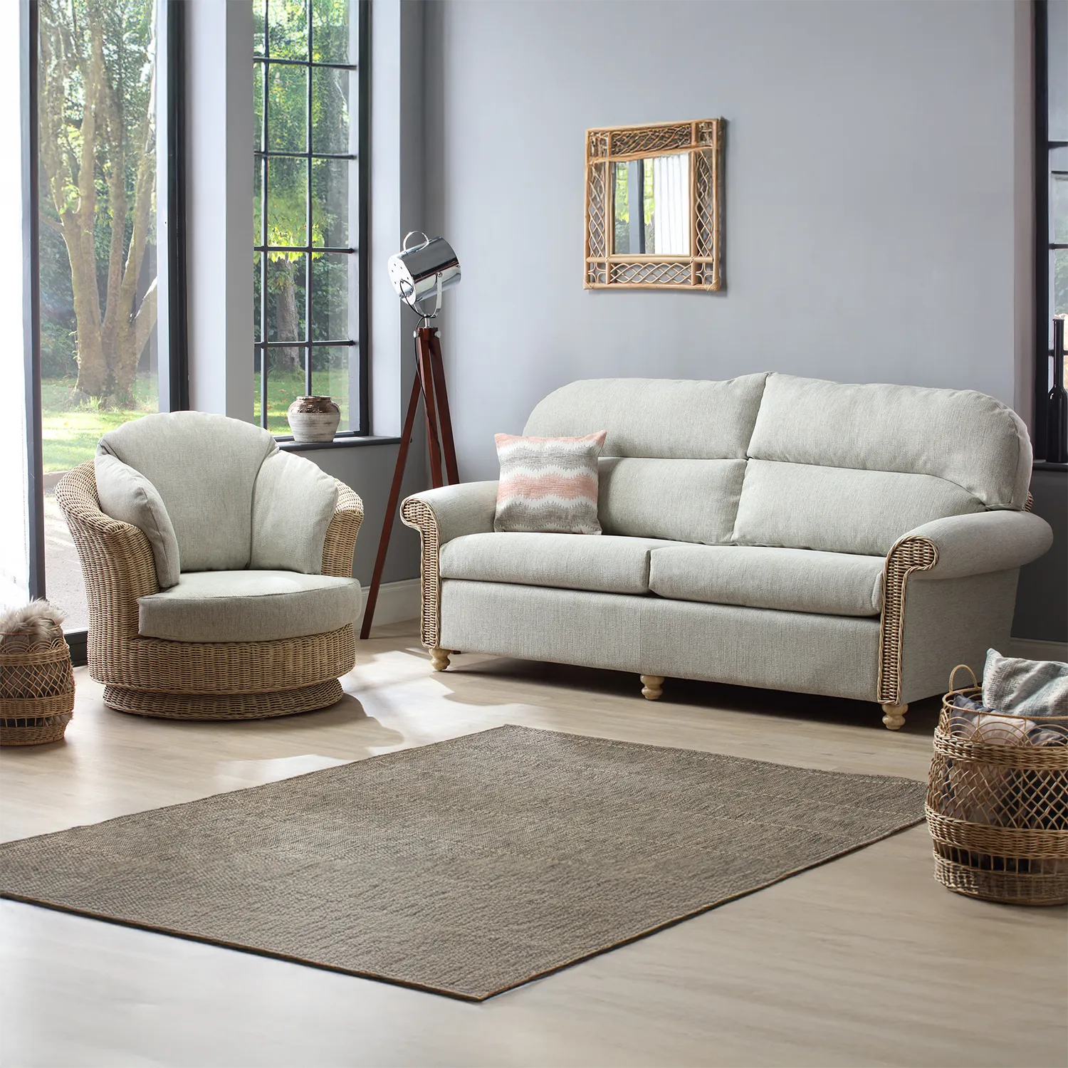 Desser Samford Rattan 3 Seater Sofa with Scatter Cushions in Pebble Fabric. Also available in 2 Seater, Swivel Chair, Swivel Rocker, Armchair and Footstool. Style with matching Coffee Table and Lamp Table. Choose from a variety of fabrics - Traditional Back Sofa Lifestyle Image 