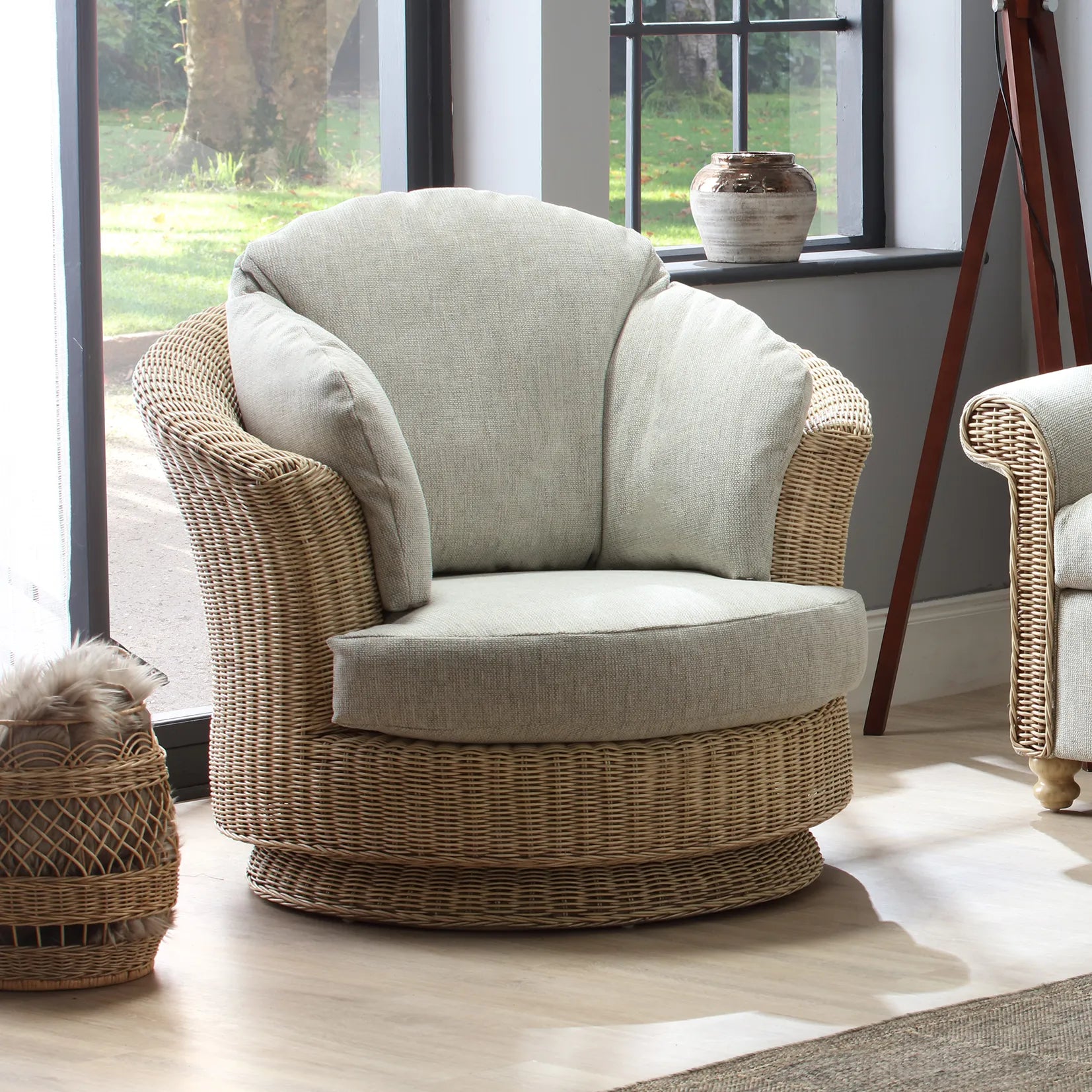 Desser Samford Rattan Swivel Chair in Pebble Fabric. Shop the Desser Samford collection and add modern elegance to your conservatory or summer house. Choose from a variety of fabrics - Lifestyle Image 