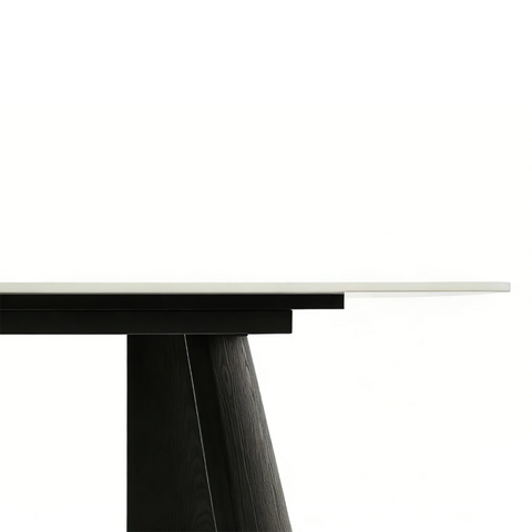 Close-up of a modern dining table with a Grey top and black base.
