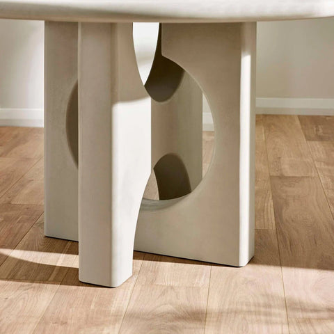 Base Close up of Thyro 120cm Round Concrete Effect Dining Table. Featuring a sculptural arch pedestal base 