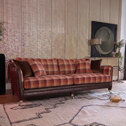 Midi sofa with fabric upholstery finial arms and brass castors.
