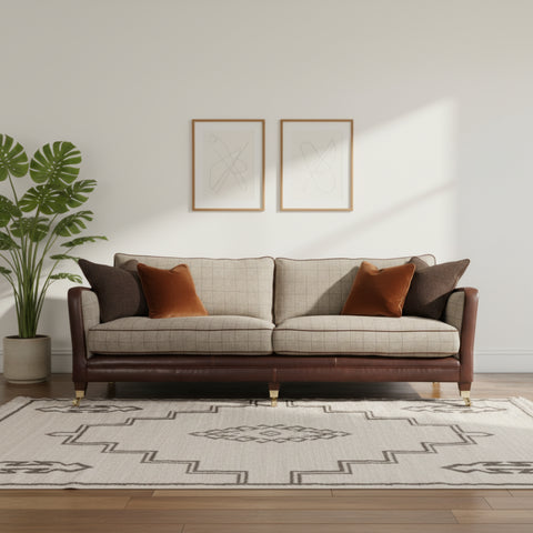 Petit sofa with fabric upholstery finial arms and brass castors.
