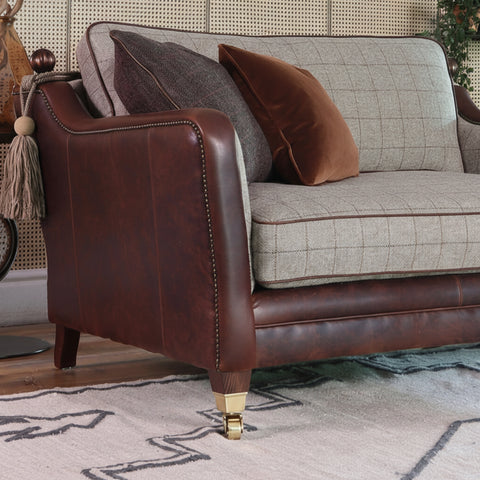 Sofas with decorative finial detailing on arm backs.