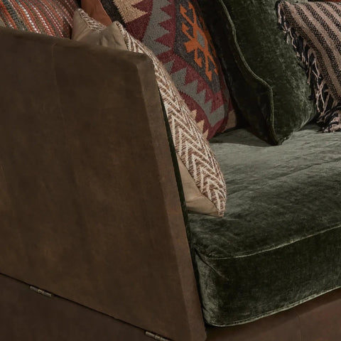 Velvet and leather upholstered sofa with rich textured finish.