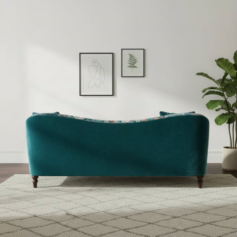 Curved back sofa with sweeping arms and sculptural form.