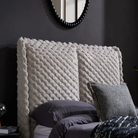 Plush tufted faux fur headboard with luxurious texture.