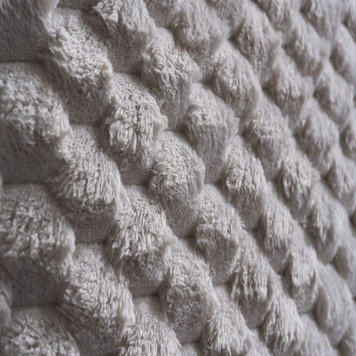 Soft faux fur headboard creating a bold statement look.
