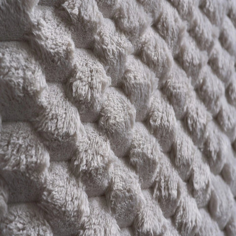 Soft faux fur headboard creating a bold statement look.
