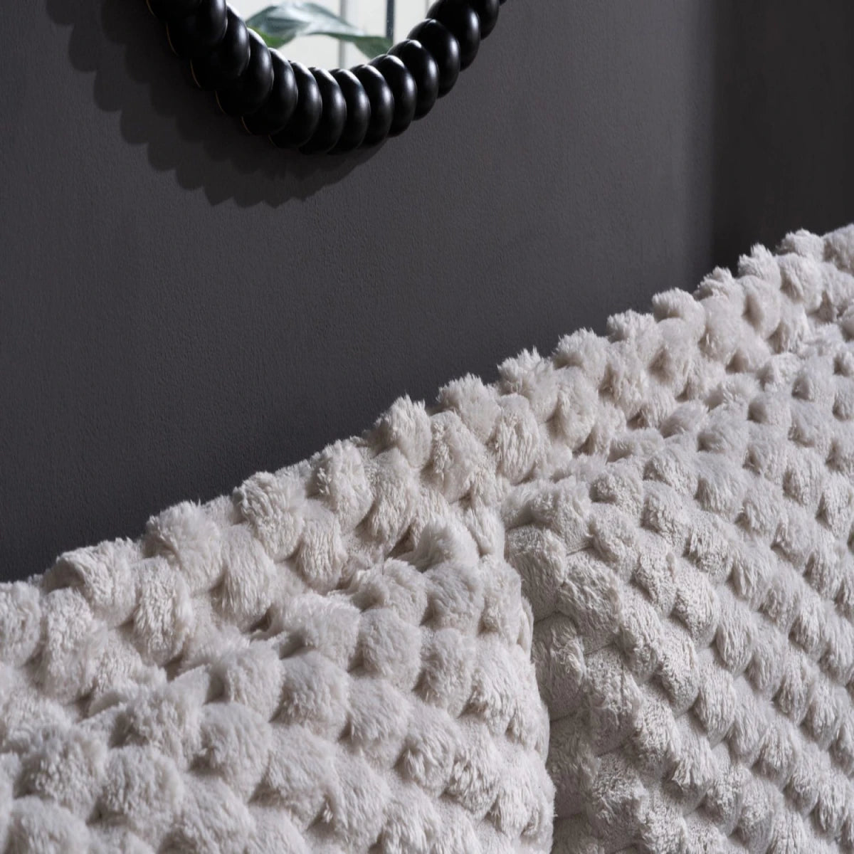 Statement headboard with cosy faux fur detailing.