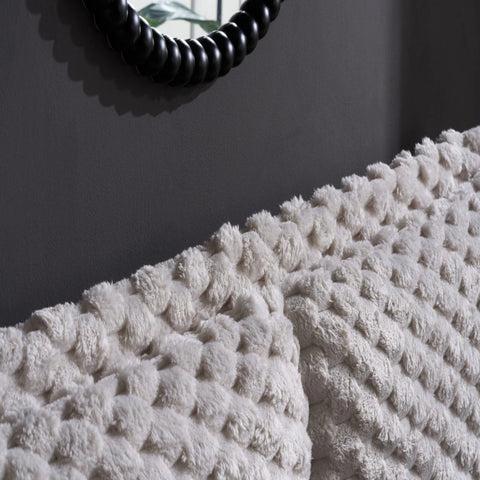 Statement headboard with cosy faux fur detailing.