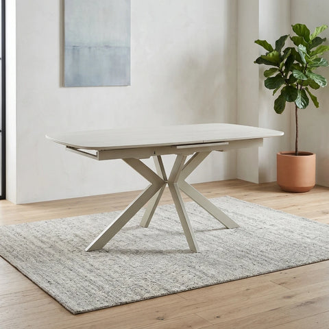Shop the Tino Travertine ceramic extending dining table with a cream metal spider base. Heat and scratch resistant ceramic top extends from 160cm to 200cm.
