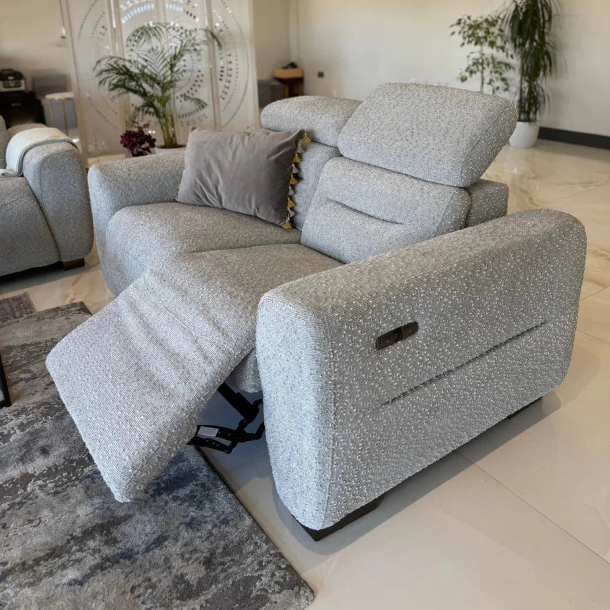 Modern electric sofa with adjustable reclining mechanism.