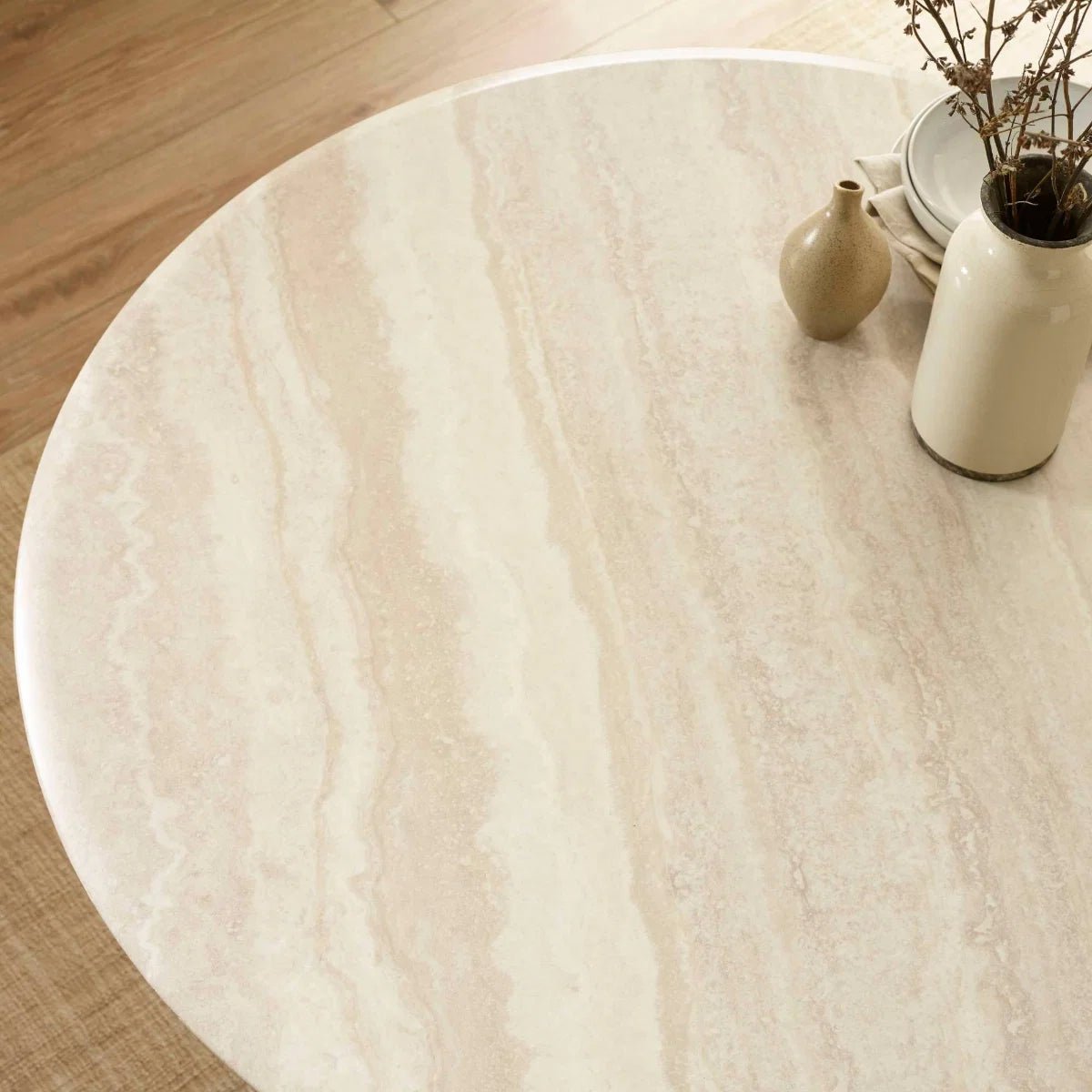 Table top close up of  Vero 120cm Round Cream Marble Effect Dining Table. Featuring a sculptural pedestal base 