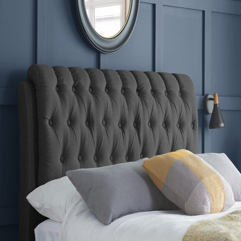 Buttoned upholstered headboard with elegant classic detailing.