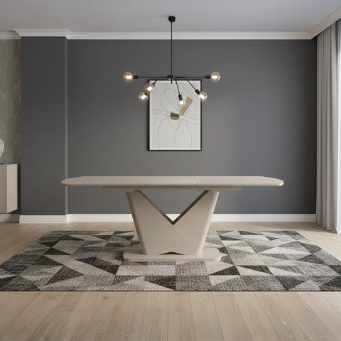 Modern dining table in a stylish room with a geometric rug and abstract art on the wall.