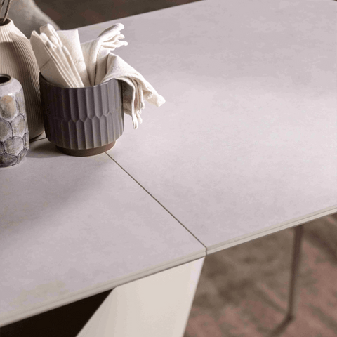 Table top of Cream sintered stone extending dining table with sculptural pedestal base