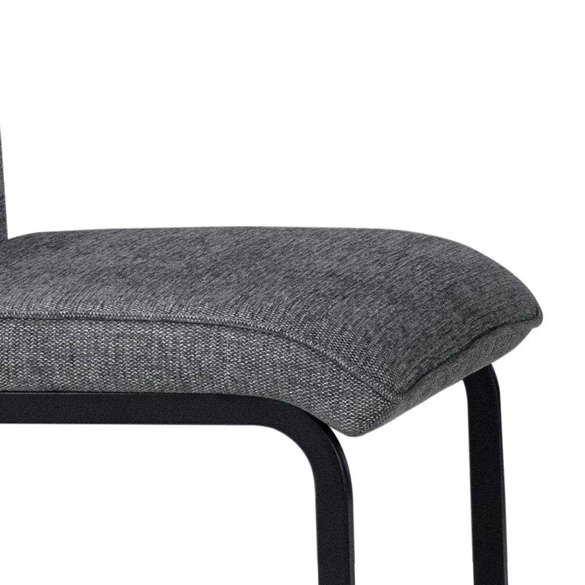 Close-up of a gray upholstered chair seat of Venezia Dark gray upholstered dining chairs with black cantilever black metal base
