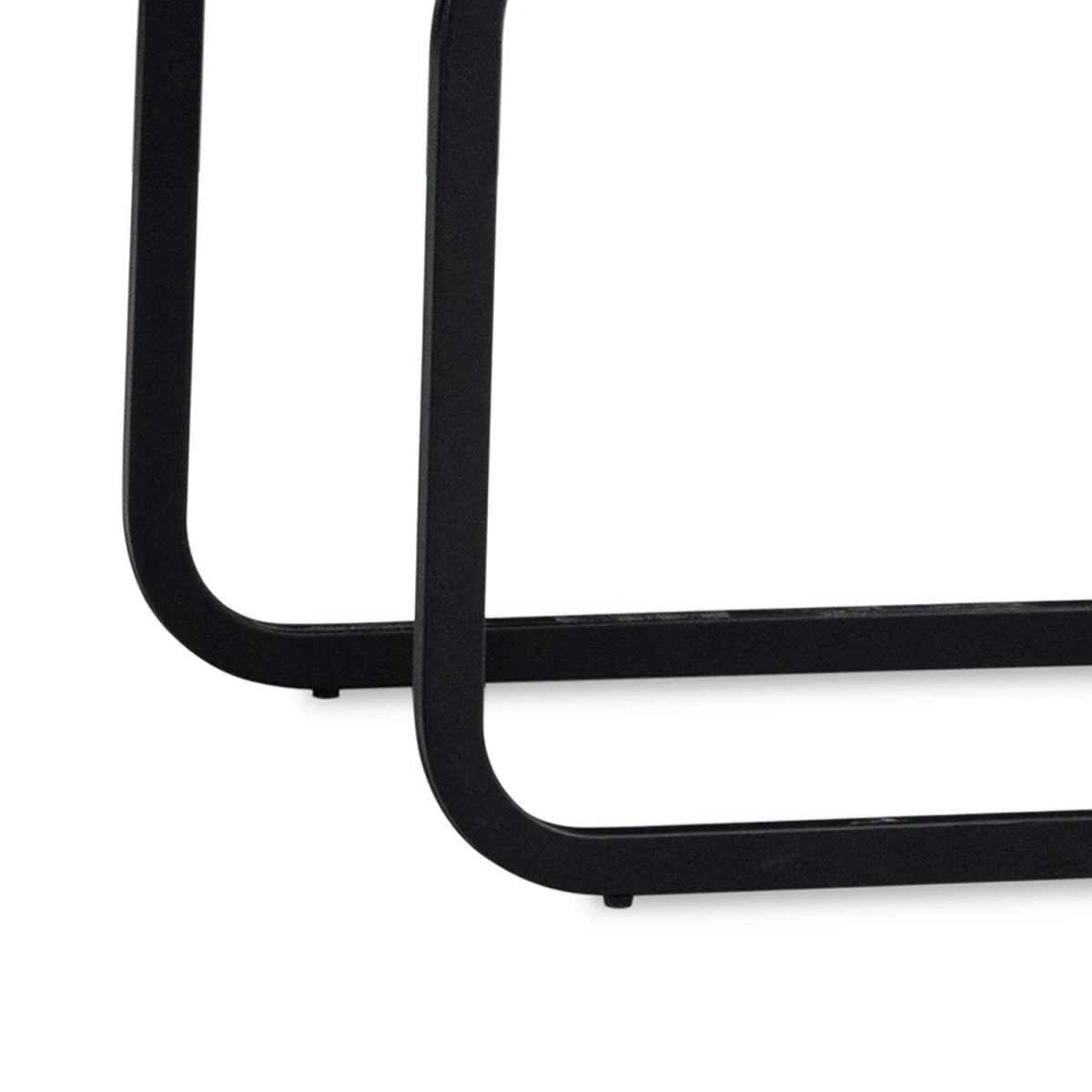 Close-up of a Venezia Dark gray upholstered dining chairs with black cantilever black metal base on a plain white background.