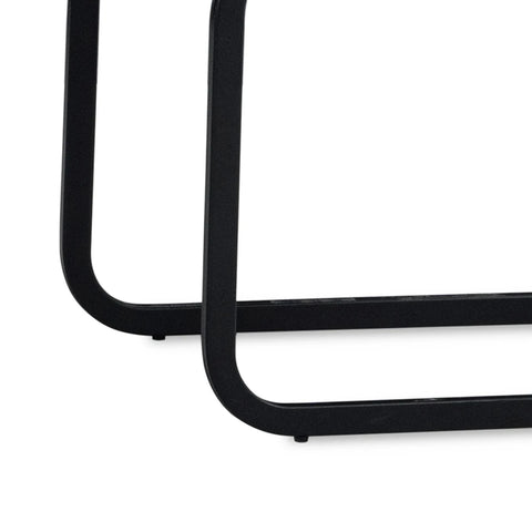 Close-up of a Venezia Dark gray upholstered dining chairs with black cantilever black metal base on a plain white background.