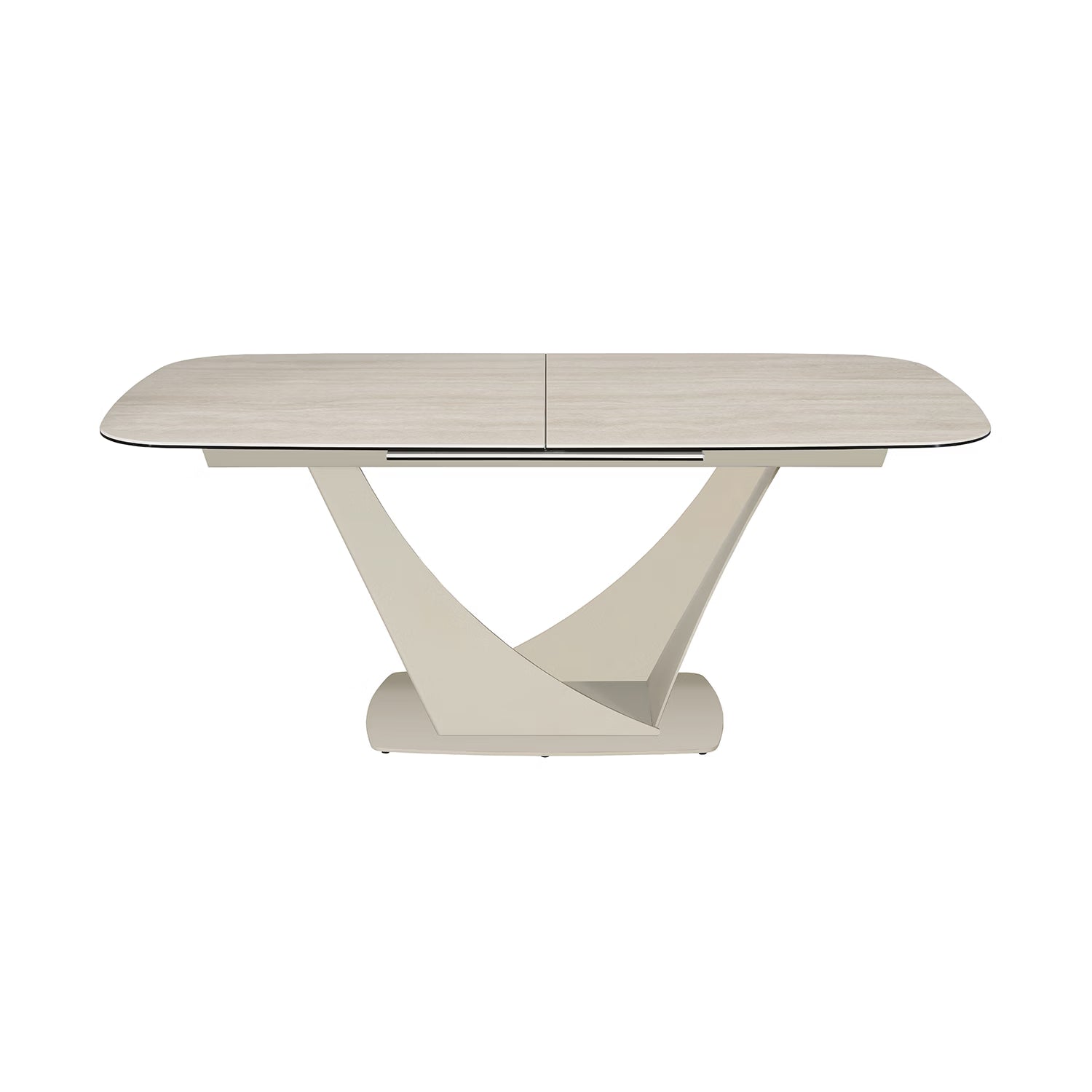 A modern rectangular dining table with a Travertine ceramic top and a sculptural, curved pedestal base in a warm off-white finish, shown on a solid white background.
