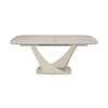 A modern rectangular dining table with a Travertine ceramic top and a sculptural, curved pedestal base in a warm off-white finish, shown on a solid white background.