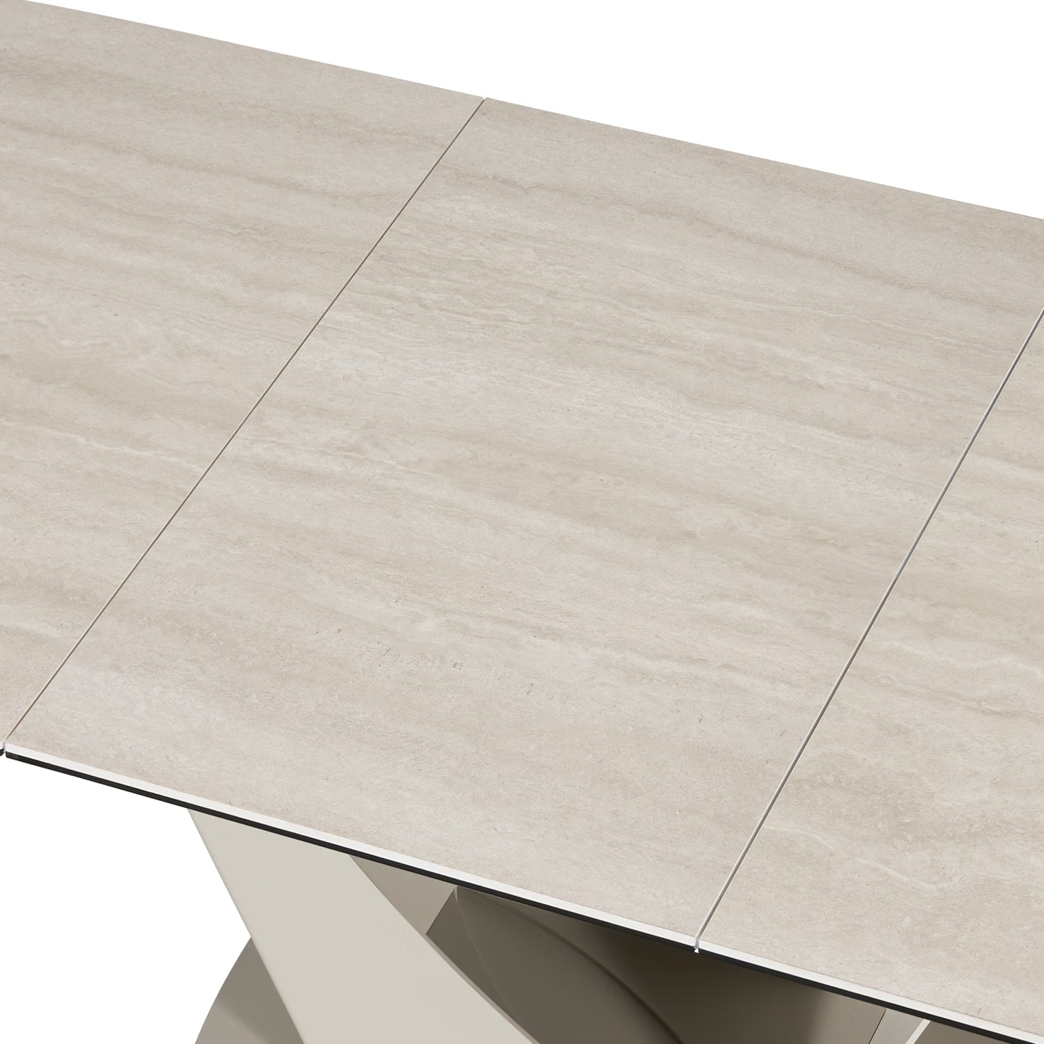 Close-up of a light beige stone-look rectangular table with a modern metallic support base, showing the tabletop seams and a portion of the base against a white background.