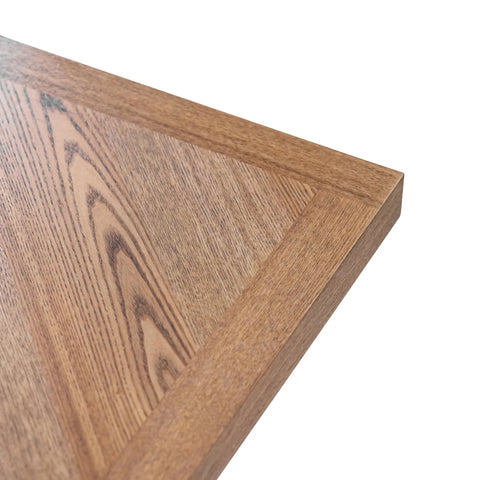 Westley Oak Veneer 1.6m Dining Table with Stone Faux Leather Corner Dining Bench and Manuelle Dining Chairs - Close-up of a wooden surface with a visible grain pattern 