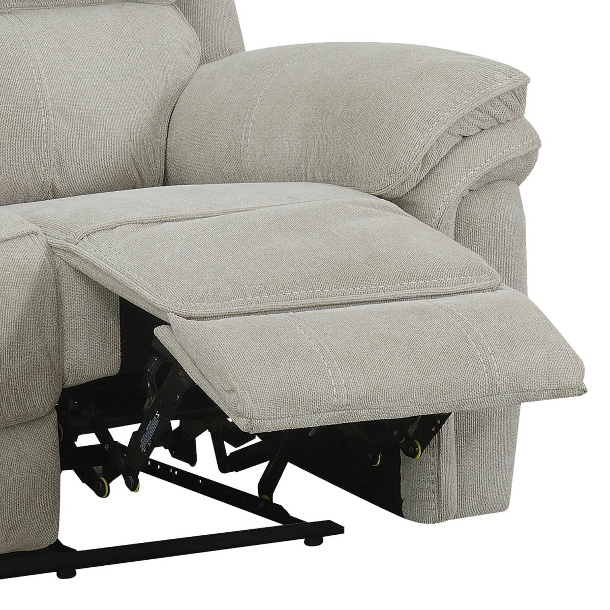 Close-up of a light beige upholstered recliner Sofa with the footrest extended, showing the fabric texture and black reclining mechanism.