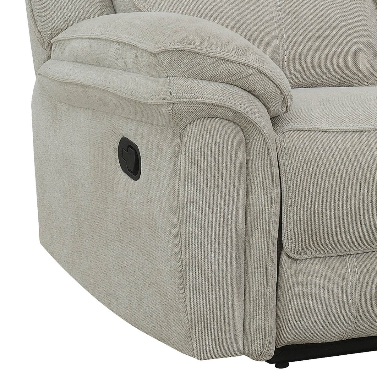 Close-up of a light beige upholstered recliner sofa showing the armrest, side panel, and a black power control button on a white background.