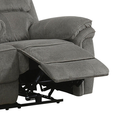 Close-up of a gray upholstered recliner chair with the footrest extended, showing the fabric texture and part of the black mechanical base against a white background.