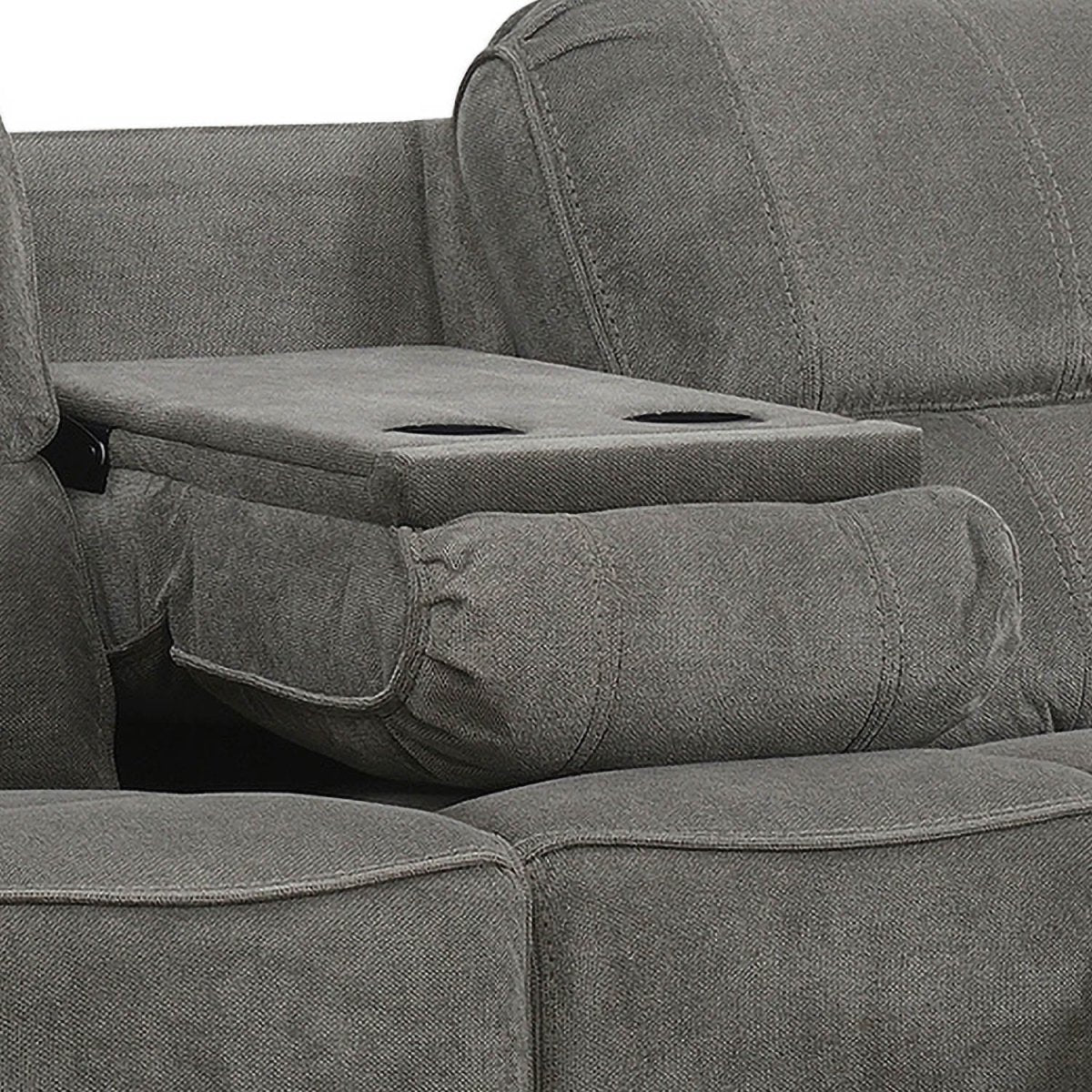 Close-up of a gray upholstered reclining sofa with a center armrest folded down into a storage ottoman featuring two cup holders, set against a plain white background.